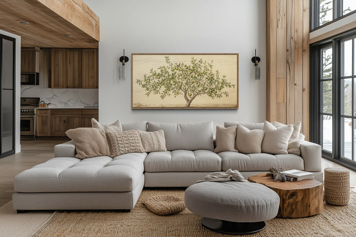 Rustic farmhouse wall art featuring a detailed apple tree canvas in a wooden frame above a sofa.