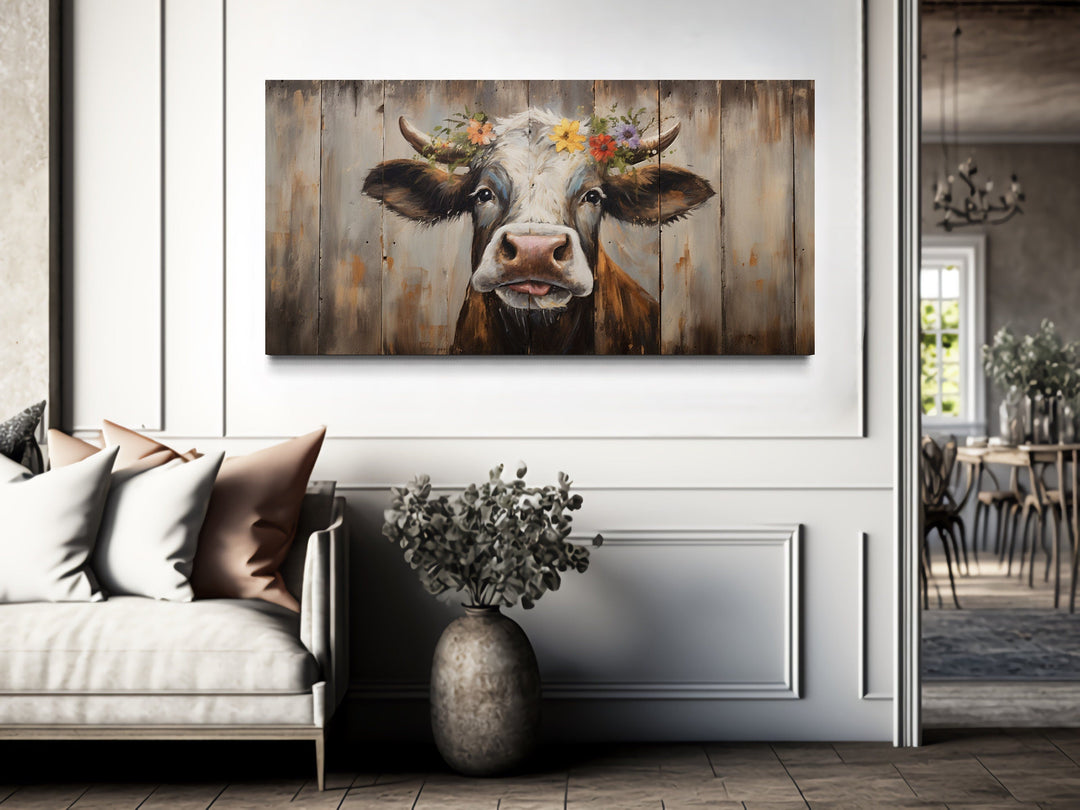 Rustic farmhouse wall art featuring a curious cow painting with a floral crown on wood-look canvas.
