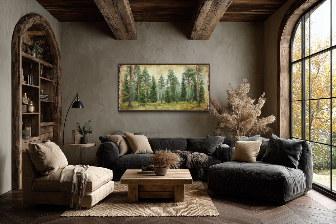 A horizontal framed canvas print of a rustic fir tree forest hangs in a cozy, earthy living room.