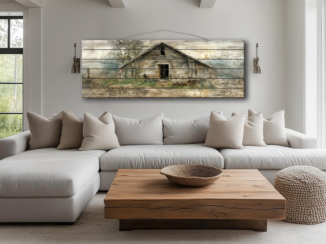Panoramic barn landscape printed on horizontal wood planks hanging above a modern farmhouse sofa.