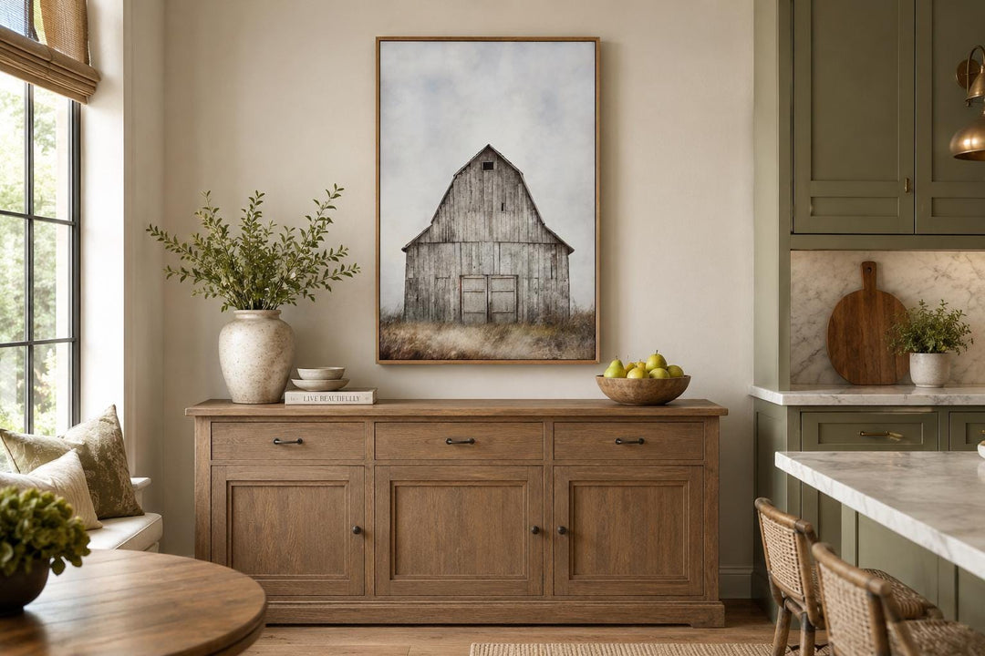 Vertical farmhouse wall decor featuring a rustic old barn in a field above a wooden sideboard.