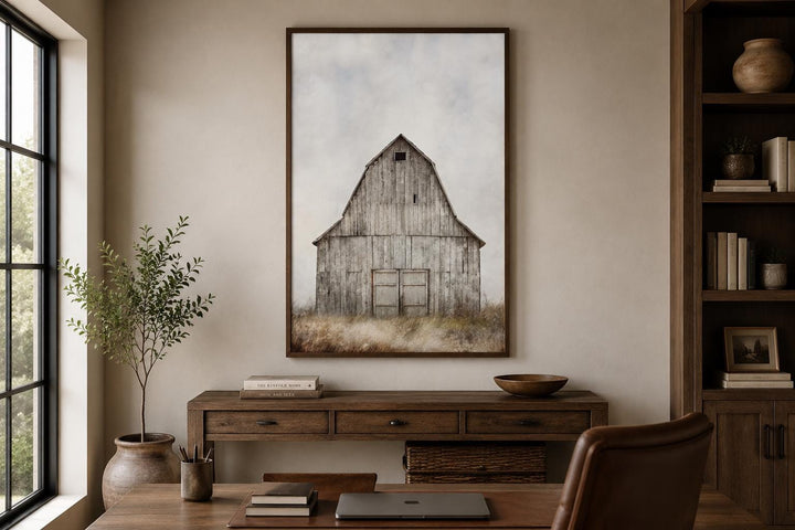 Rustic vertical canvas print of a weathered old barn in a field, hanging above a wooden console.
