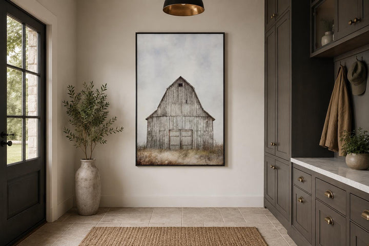 Rustic vertical canvas print of a weathered old barn in a field, hanging in a farmhouse entryway.