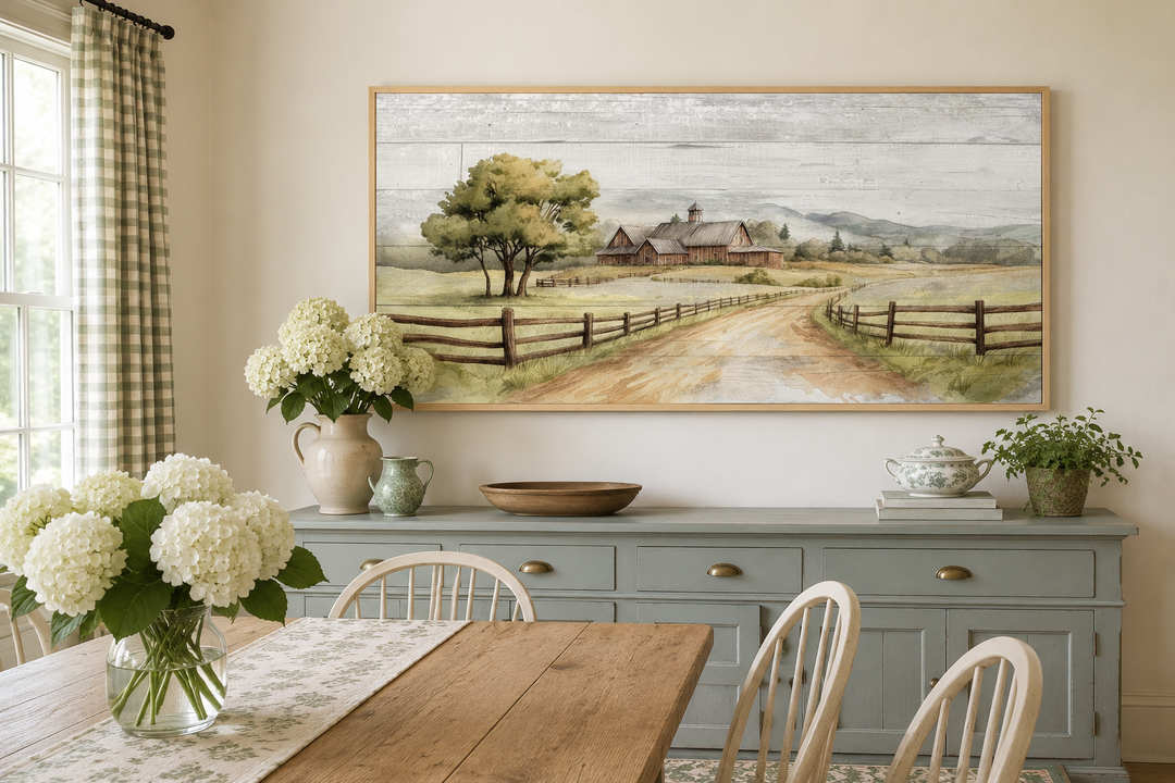 Rustic old barn landscape painting on wood-effect canvas, framed and hung in a farmhouse dining room.