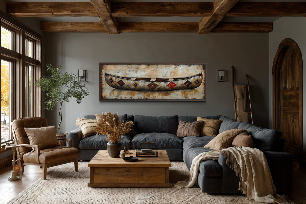 Rustic old wooden canoe painting on framed canvas above a dark grey sectional sofa in a cabin room.