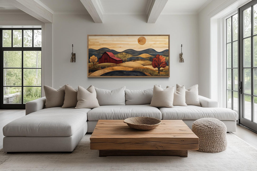 Rustic red barn and farm landscape wood style canvas wall art hanging above a modern sofa.