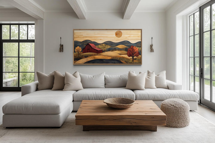 Rustic red barn and farm landscape wood style canvas wall art hanging above a modern sofa.