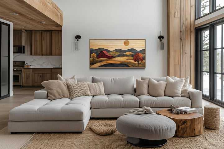 Rustic red barn and farm landscape wood style canvas wall art hanging above a modern sectional sofa.
