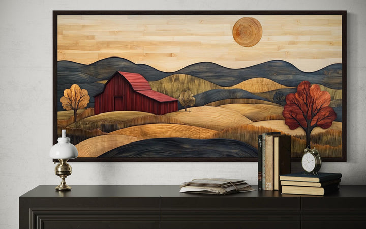 Rustic red barn and farm landscape wood-style canvas wall art in a dark frame above a sideboard.