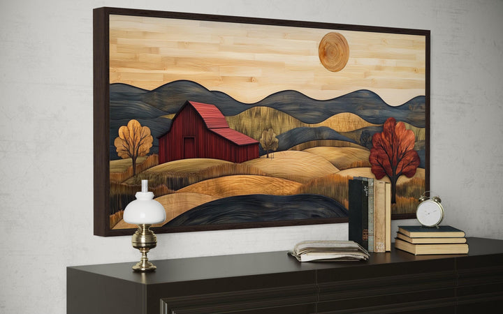 Rustic red barn and farm landscape wood style canvas wall art framed above a dark wood dresser.