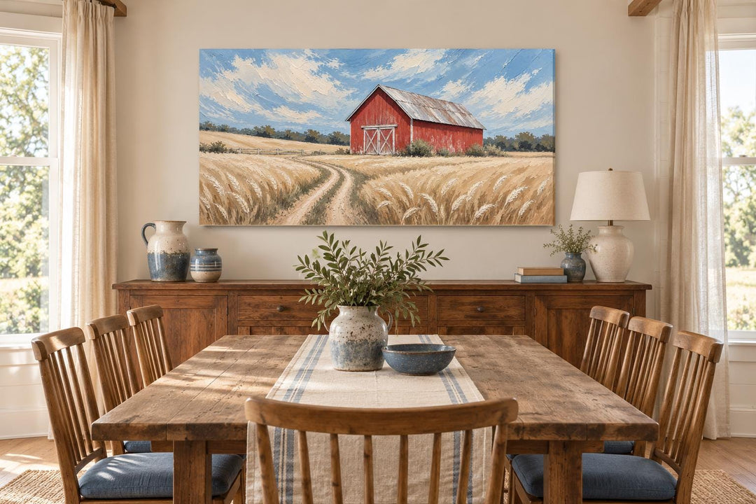 Rustic red barn in a golden wheat field landscape canvas wall art hanging in a dining room.