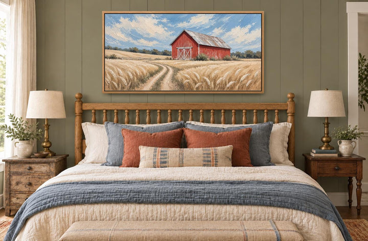 Rustic red barn in a golden wheat field landscape canvas wall art hanging above a wooden bed frame.