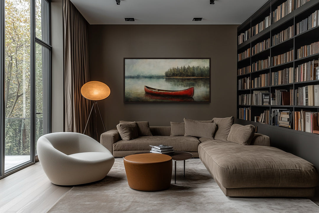Rustic red canoe in a lake framed canvas wall art hanging in a modern living room.