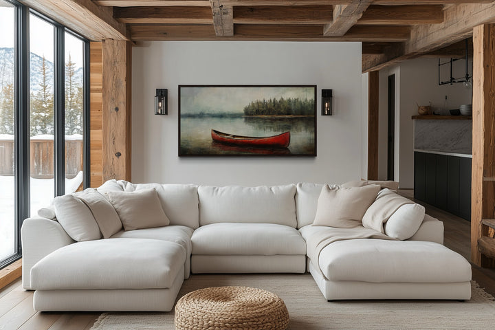 Rustic red canoe in a lake framed canvas wall art hanging above a white sectional sofa.