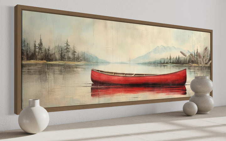 Rustic red canoe on a calm lake painted on wood-effect framed canvas wall art.