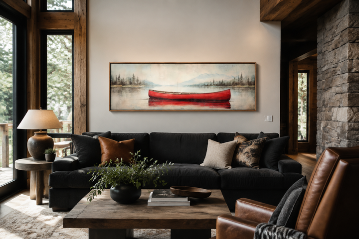 Rustic red canoe on a calm lake, framed horizontal wood-effect canvas wall art above a dark sofa.