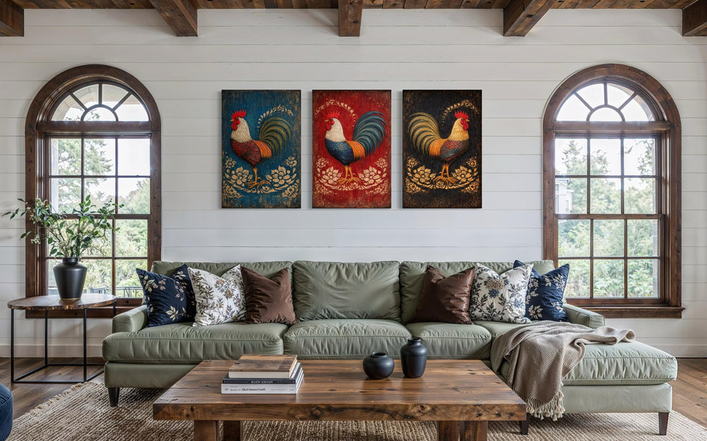Three-panel rustic rooster canvas wall art set displayed above a green sofa in a farmhouse room.