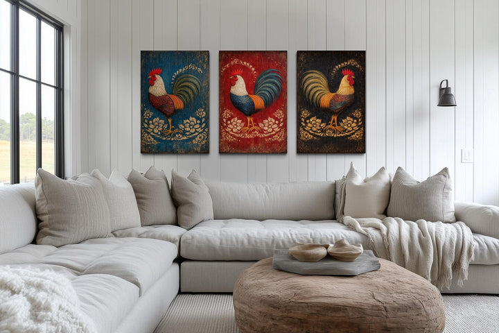 Three-panel rustic rooster canvas print set displayed on a white shiplap wall above a neutral sofa.