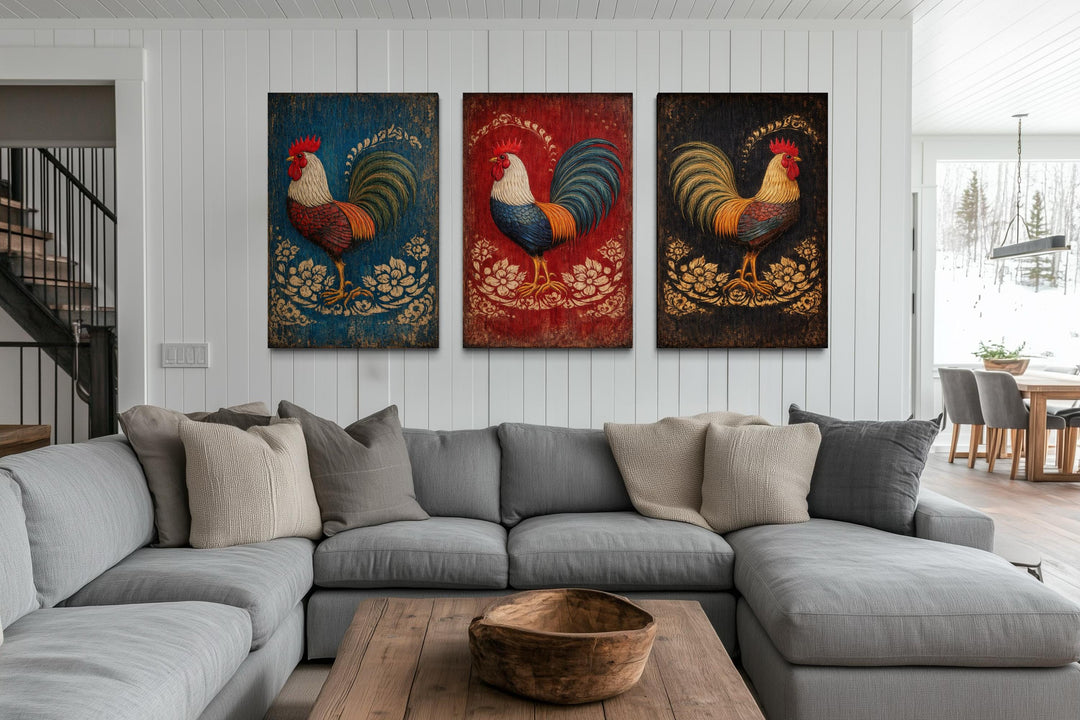 Three-panel rustic rooster canvas art set displayed on a white wall above a gray sectional sofa.