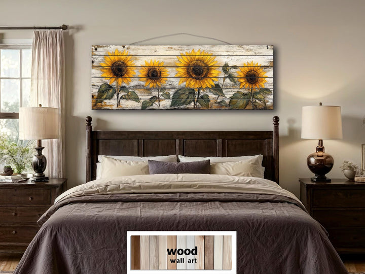 Rustic sunflower wall art on a long whitewashed wood panel displayed above a bed.