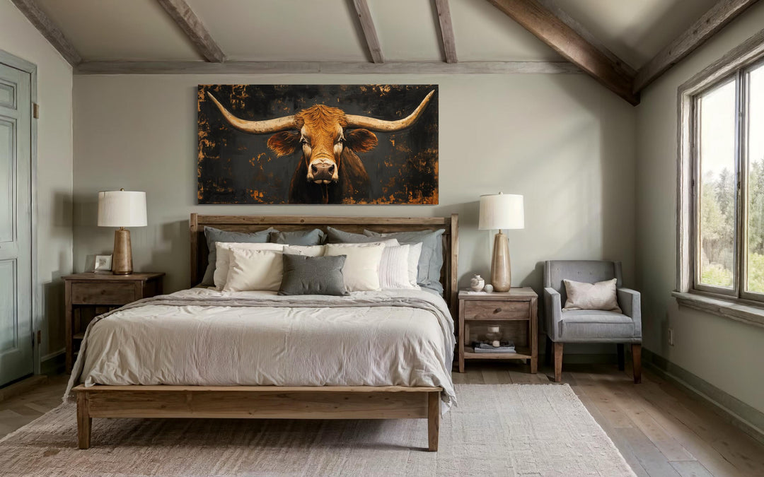 Extra large rustic Texas longhorn cow wall art hanging above a bed in a western-style bedroom.