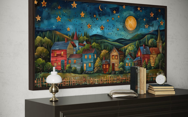 Rustic village wall art featuring colorful houses under a starry night sky and full moon.