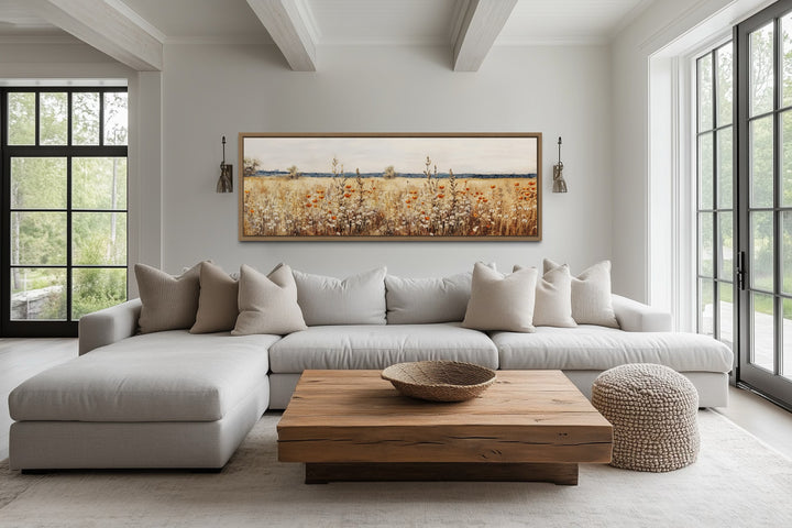 Rustic vintage yellow wildflowers field horizontal canvas wall art displayed above a modern sofa.