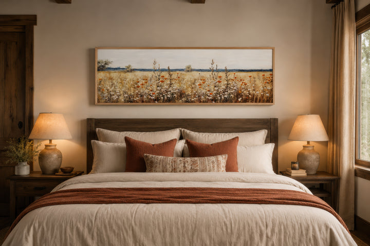 A horizontal canvas wall art of a rustic vintage yellow wildflower field hangs above a bed.