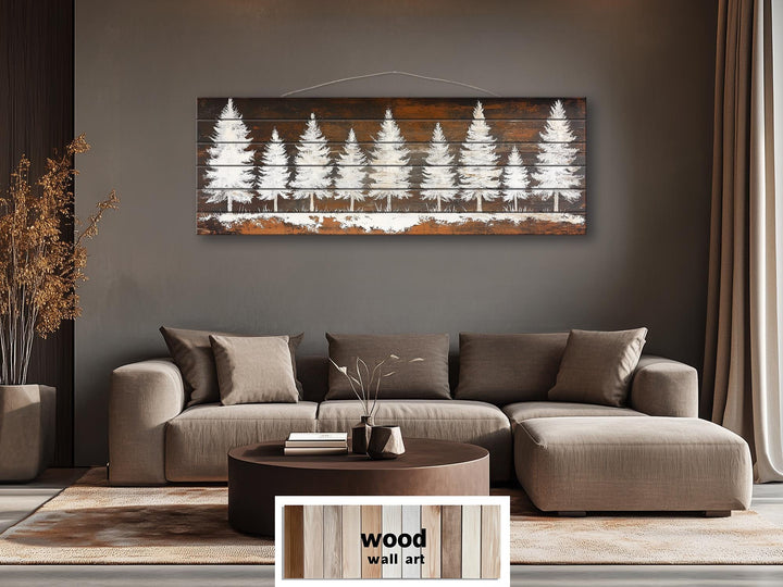 Rustic white pine tree silhouettes on a long, narrow distressed wood wall art piece above a sofa.