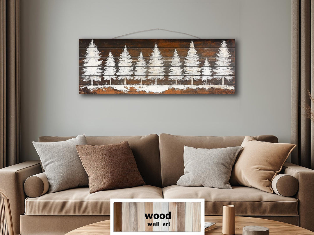 Rustic white pine tree silhouettes on a long, narrow distressed wood plank wall art piece.