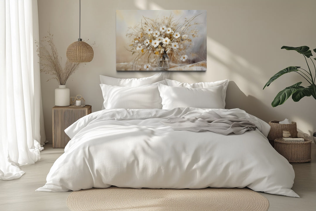 Rustic white wildflower bouquet canvas wall art hanging above a bed in a neutral farmhouse bedroom.