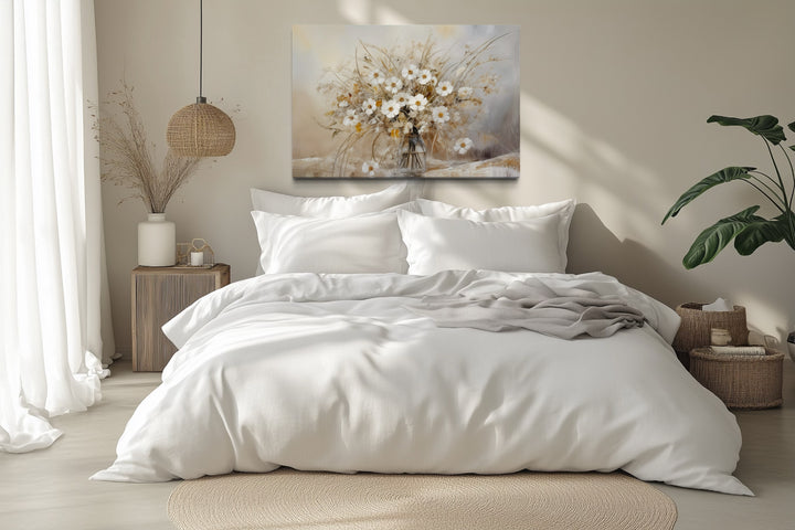 Rustic white wildflower bouquet canvas wall art hanging above a bed in a neutral farmhouse bedroom.