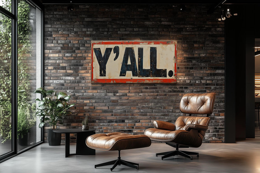 a modern living room with a brick wall, a large "Y'ALL" sign, a leather chair, and a matching ottoman.