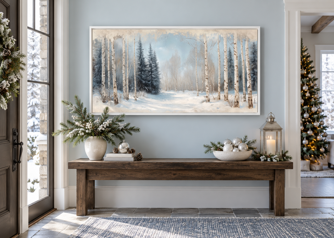 Rustic Birch Trees Forest in Winter canvas wall art in a white frame above a wooden entryway bench.