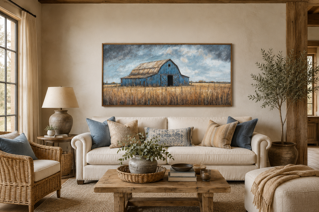 Rustic blue barn framed canvas wall art hanging above a sofa in a farmhouse style living room.