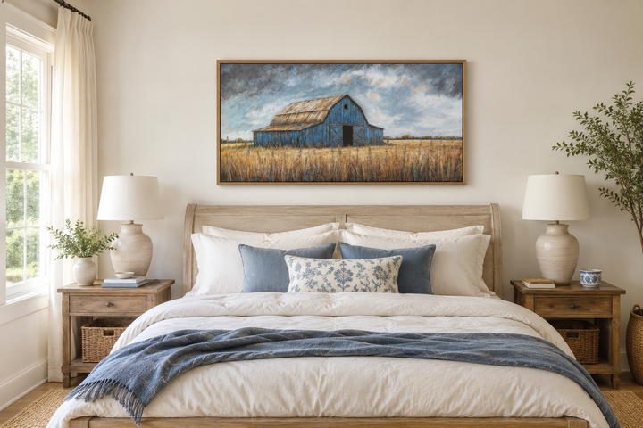 Rustic blue barn framed canvas wall art hanging above a bed in a farmhouse style bedroom.