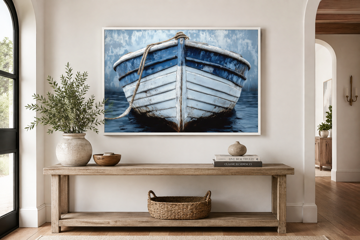 Rustic blue and white distressed boat canvas art framed above a wooden console table.