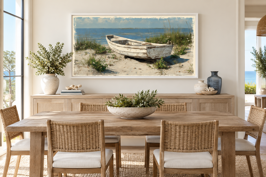 Old white boat on beach coastal framed canvas wall art above a wooden dining table.