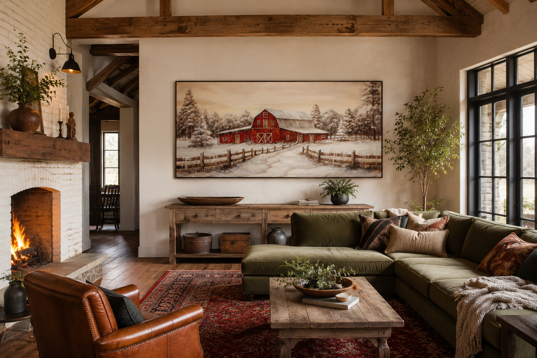 Large framed canvas wall art of a red barn in a snowy winter landscape above a wooden console table.