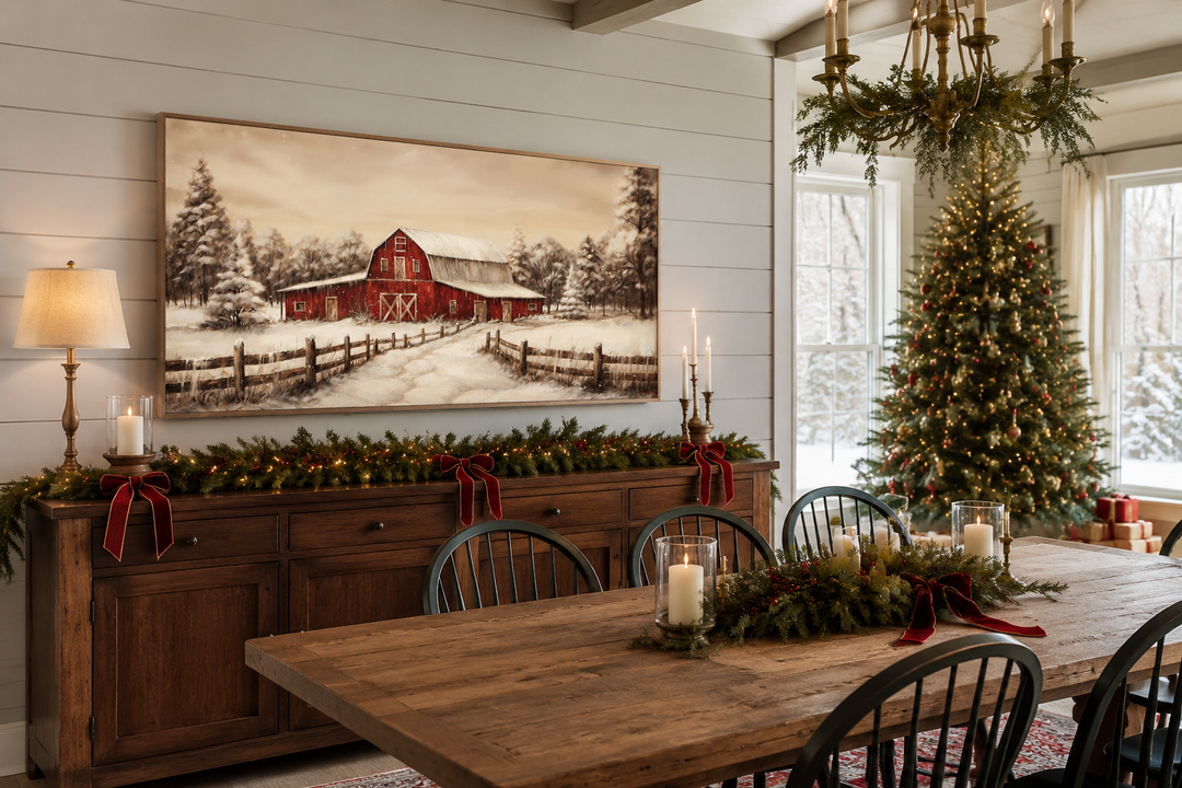 Framed canvas wall art of a red barn in a snowy winter landscape above a Christmas mantel.