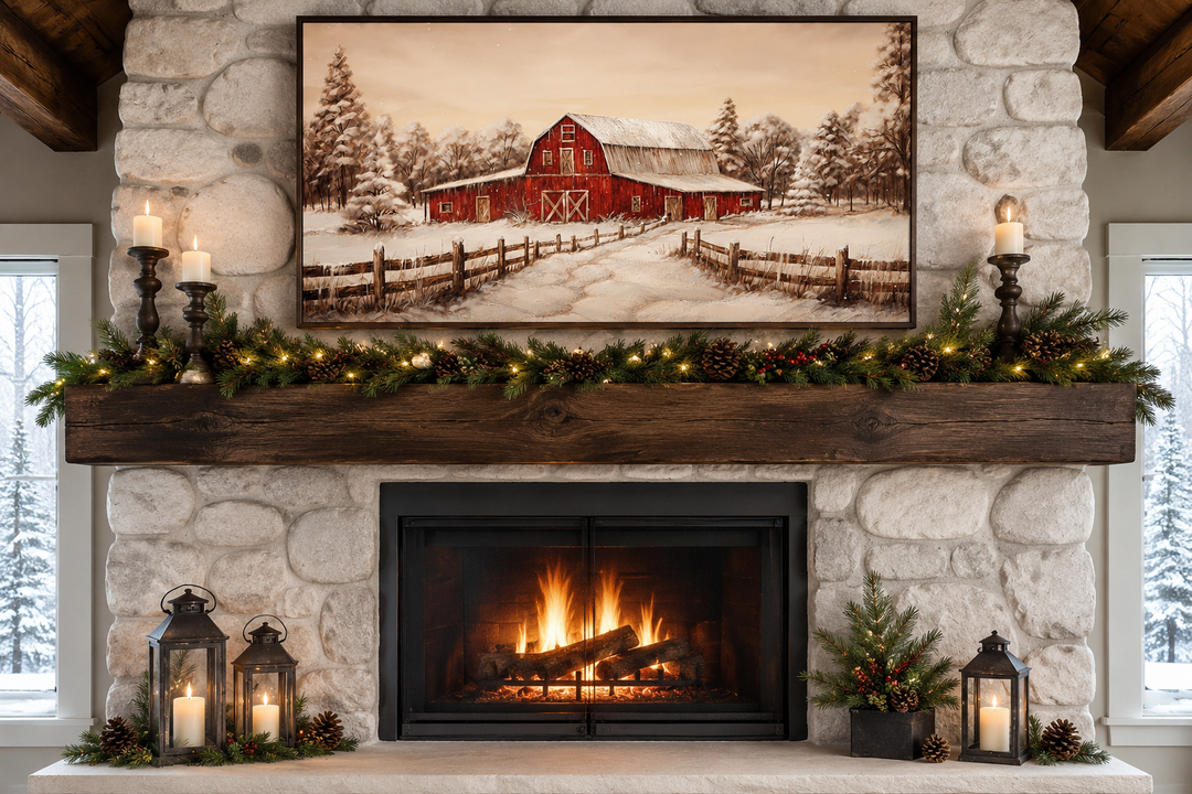 Framed canvas wall art of a red barn in a snowy winter landscape displayed above a fireplace mantel.