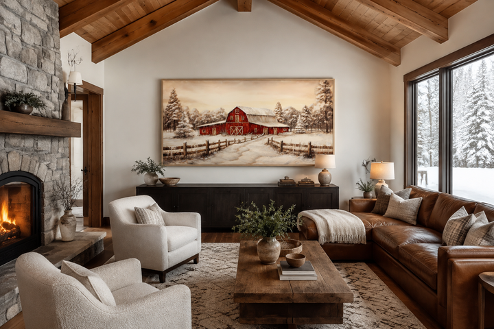 Framed canvas wall art of a red barn in a snowy winter landscape above a living room mantel.