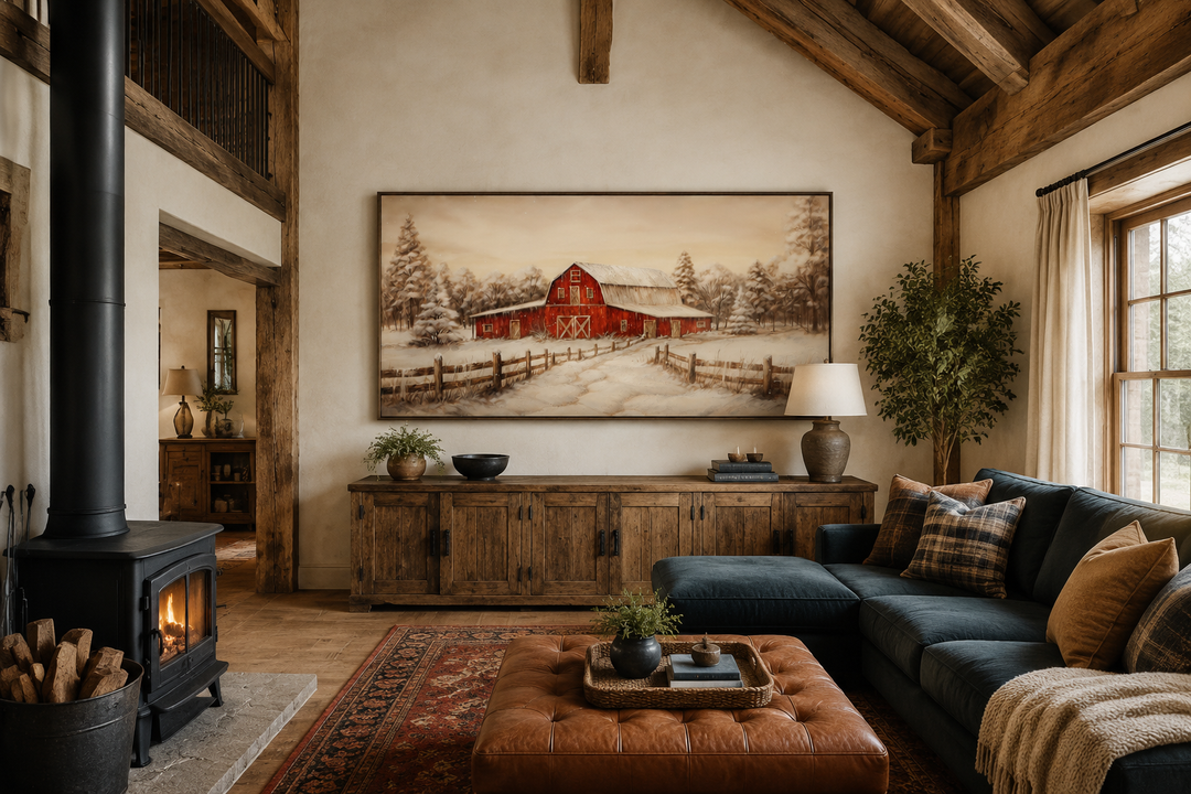 Framed canvas wall art of a red barn in a snowy winter landscape above a rustic wooden sideboard.