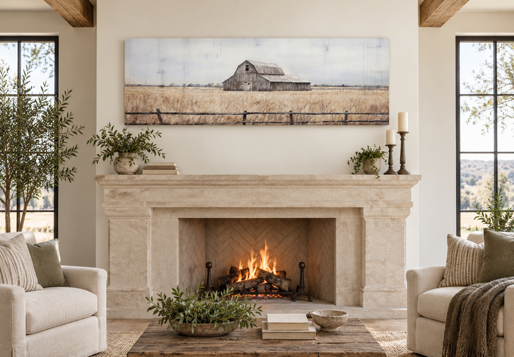Rustic long narrow framed canvas wall art featuring an old barn painting above a fireplace mantel.