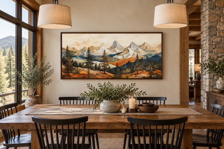 Rustic mountain wall art with layered wood panel effect hanging above a wooden dining table.