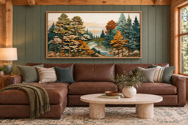 Layered wood forest river wall art in a rustic frame above a brown leather sectional sofa.