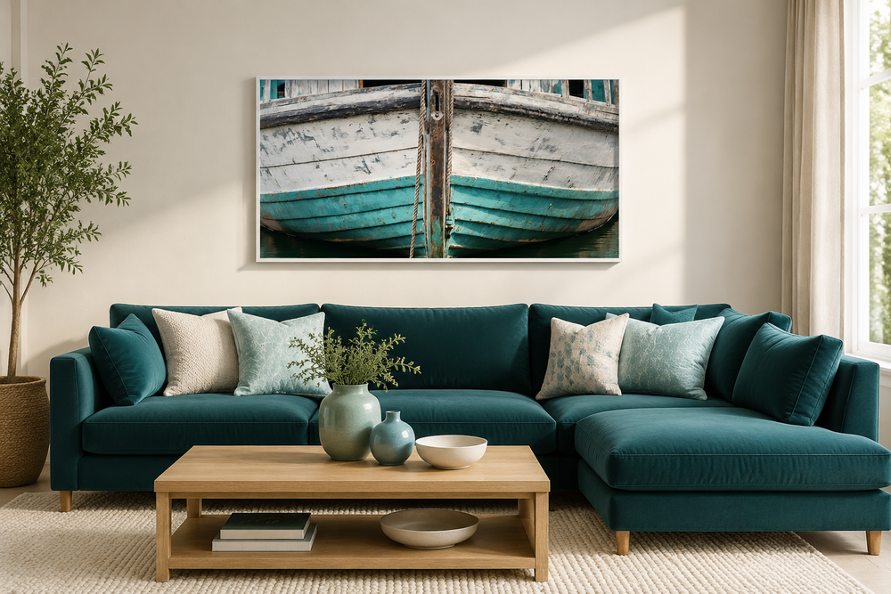 Rustic old teal boat close-up framed canvas wall art hanging above a teal sectional sofa.