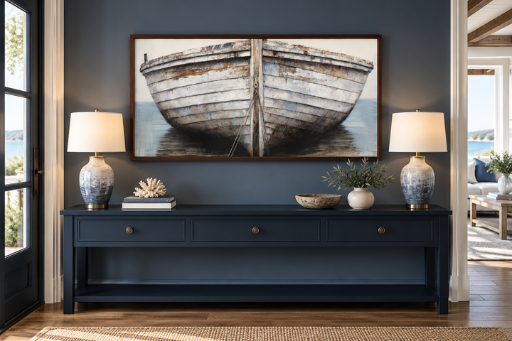 Rustic old white and brown boat close-up framed canvas wall art above a navy blue console table.