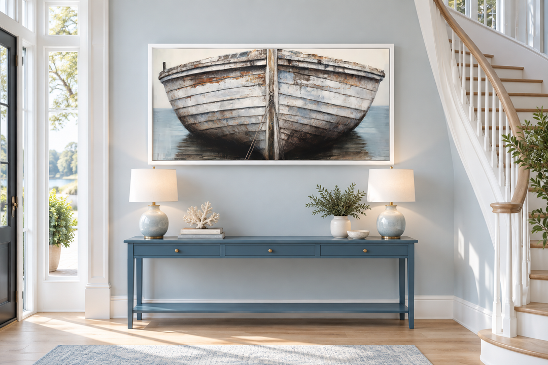 Rustic old boat close-up framed canvas wall art above a blue console table in a coastal entryway.