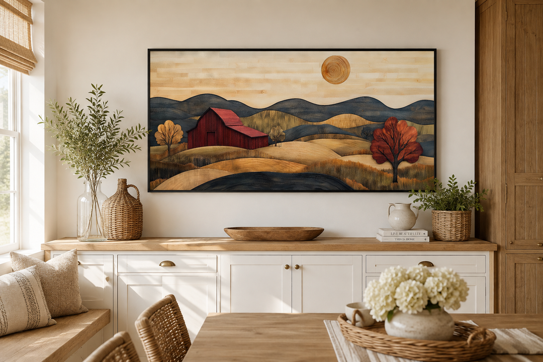 Rustic red barn and farm landscape wood style canvas wall art in a black frame over a sideboard.